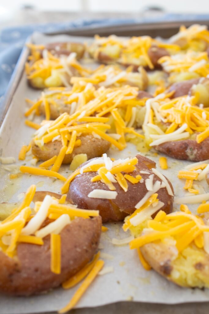 sprinkling potatoes with cheese