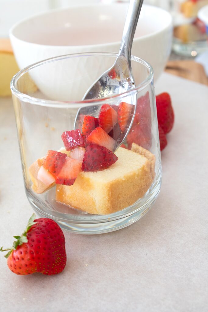 adding strawberries to a cup