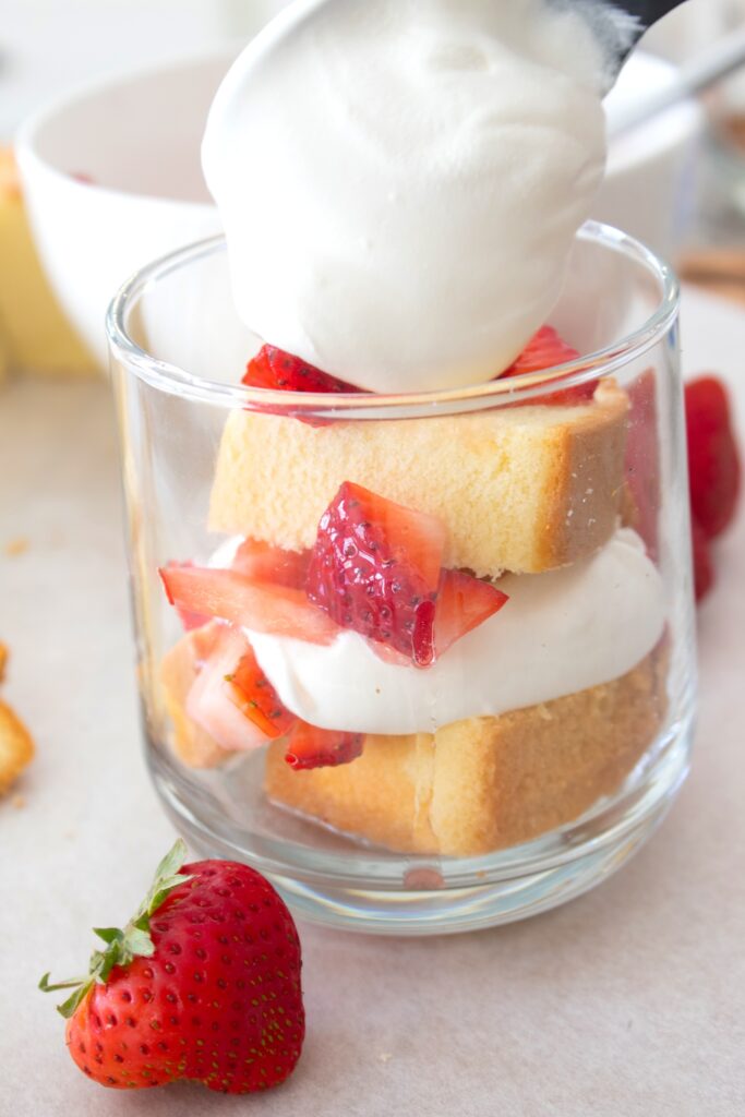 layering cool whip in strawberry shortcake cups